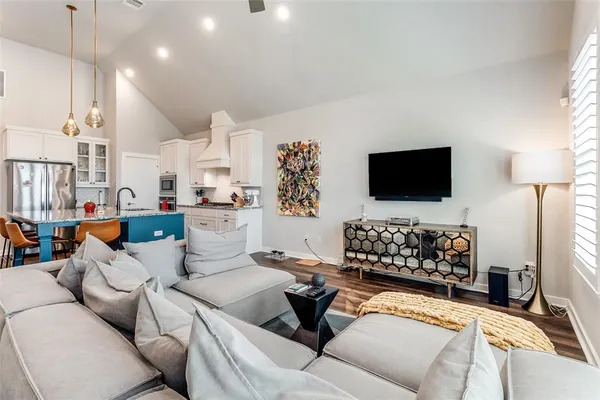 a living room with furniture and kitchen view