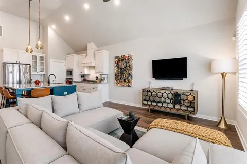 a kitchen with a stove center island a table and chairs in it