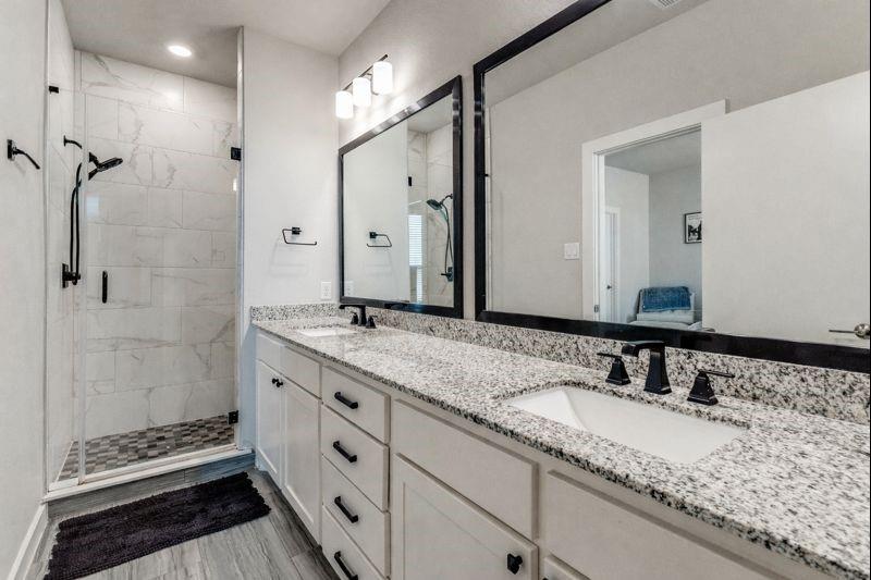 2220 Rook Drive Dallas, TX 75211 - Photo 10 of 13 a bathroom with a granite countertop sink and a mirror
