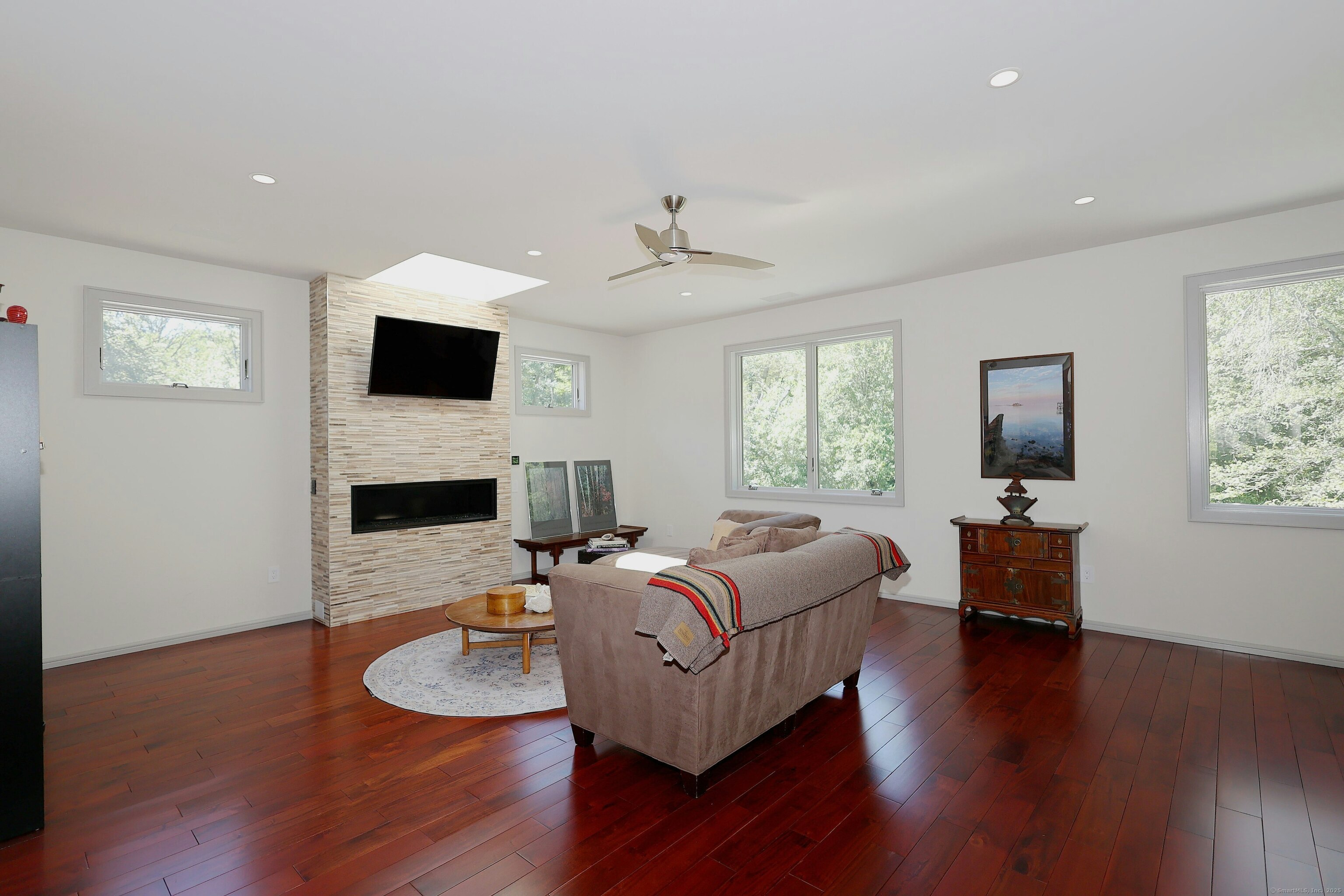 88 Green Lane Ridgefield, CT 06877 - Photo 23 of 40 a living room with furniture a fireplace and a flat screen tv
