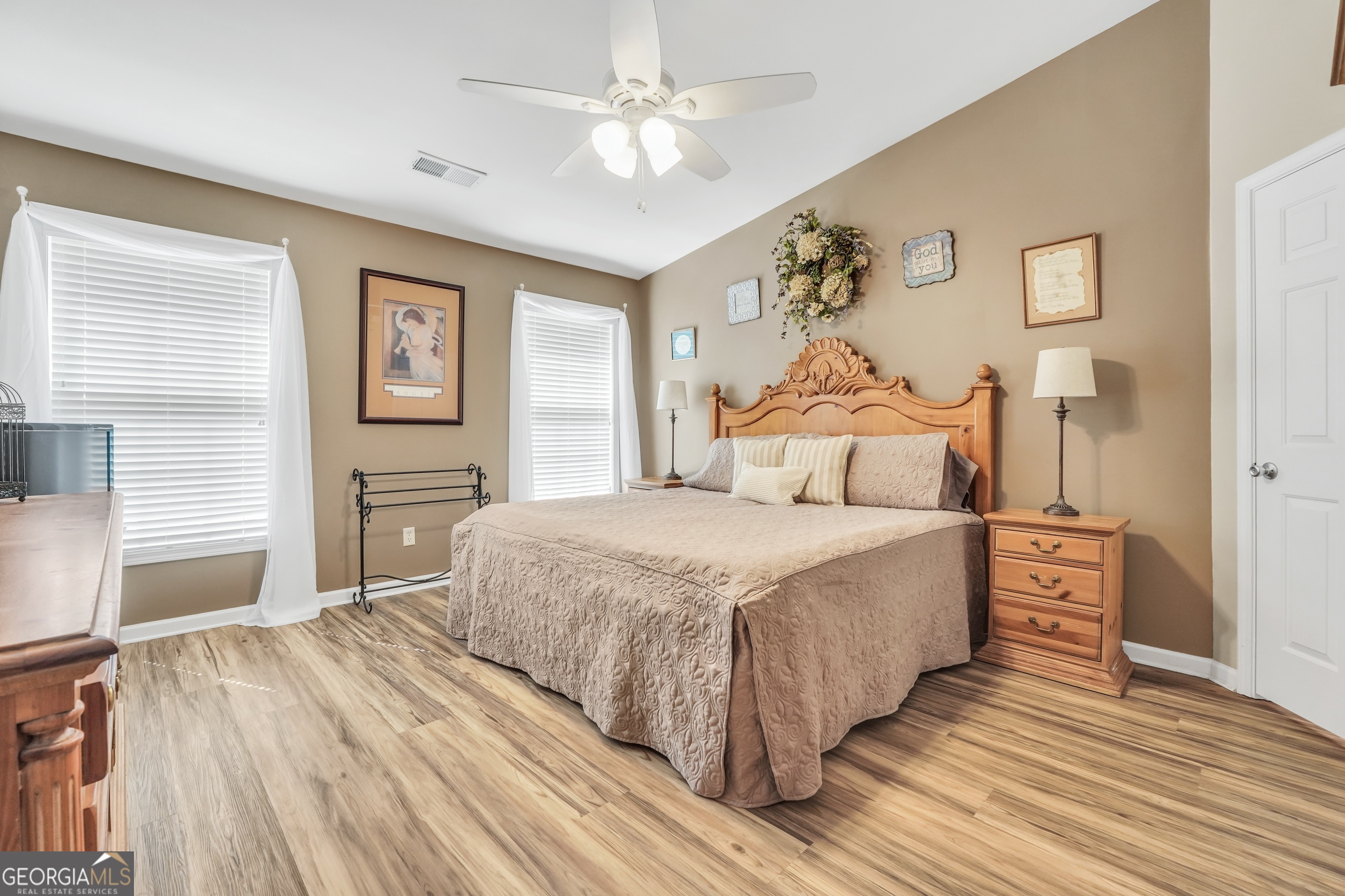 164 Lantana Drive Locust Grove, GA 30248 - Photo 16 of 34 a bedroom with a large bed and a chandelier
