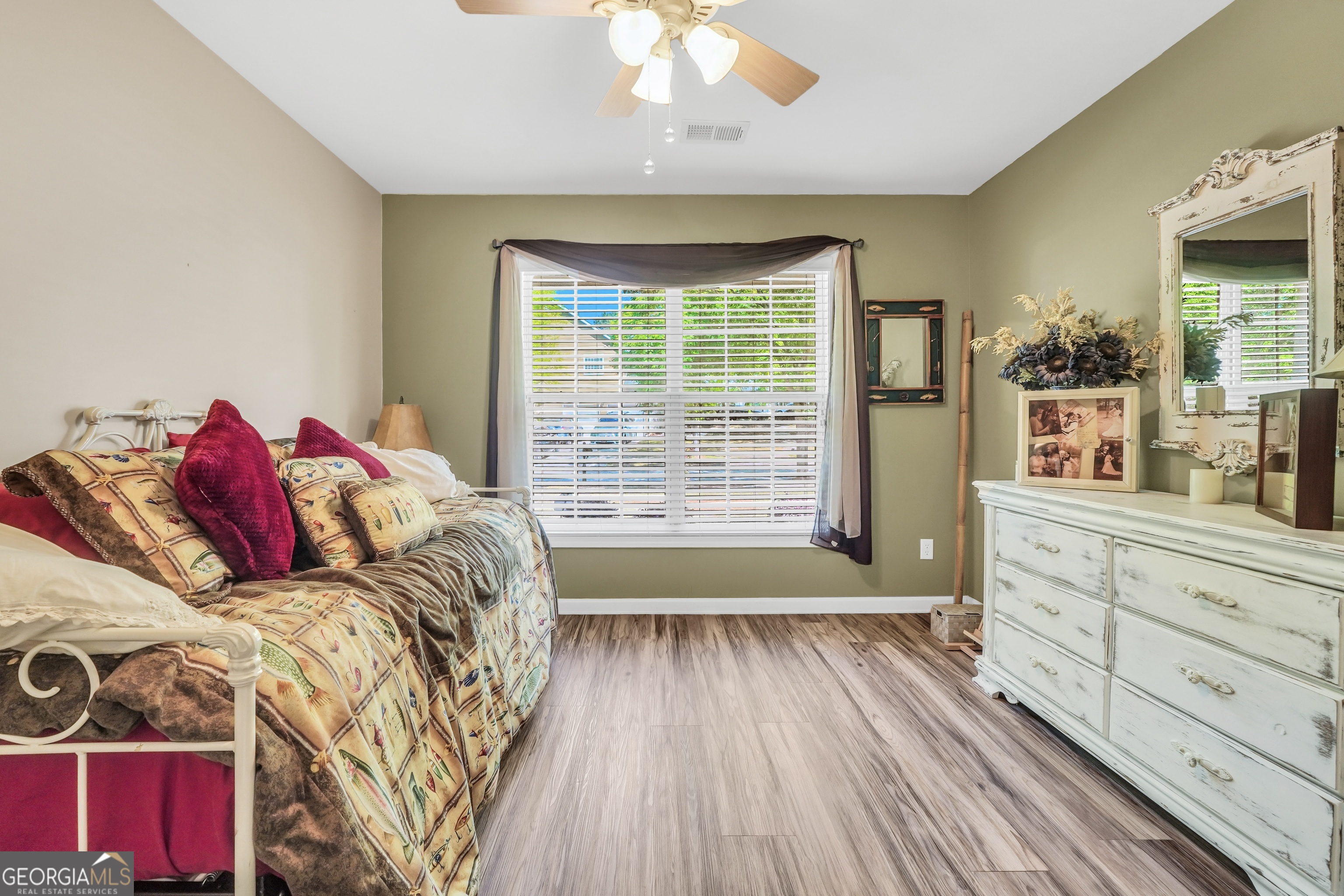164 Lantana Drive Locust Grove, GA 30248 - Photo 25 of 34 a bed sitting in a bedroom next to a window