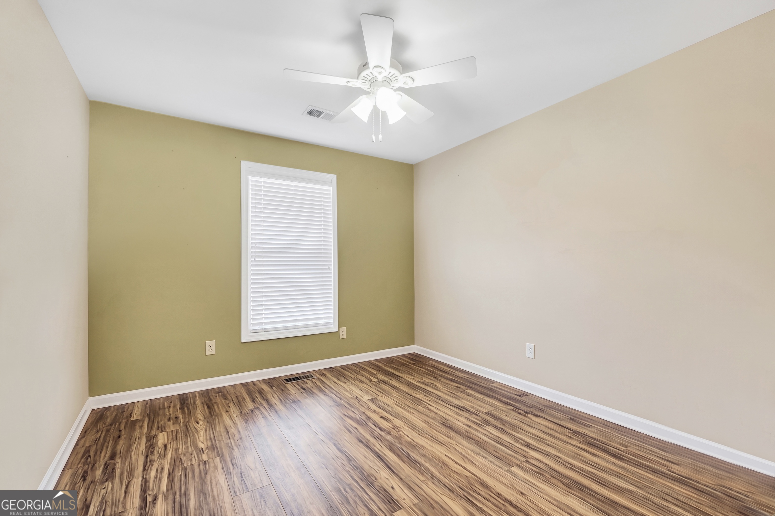 164 Lantana Drive Locust Grove, GA 30248 - Photo 27 of 34 an empty room with a window and wooden floor