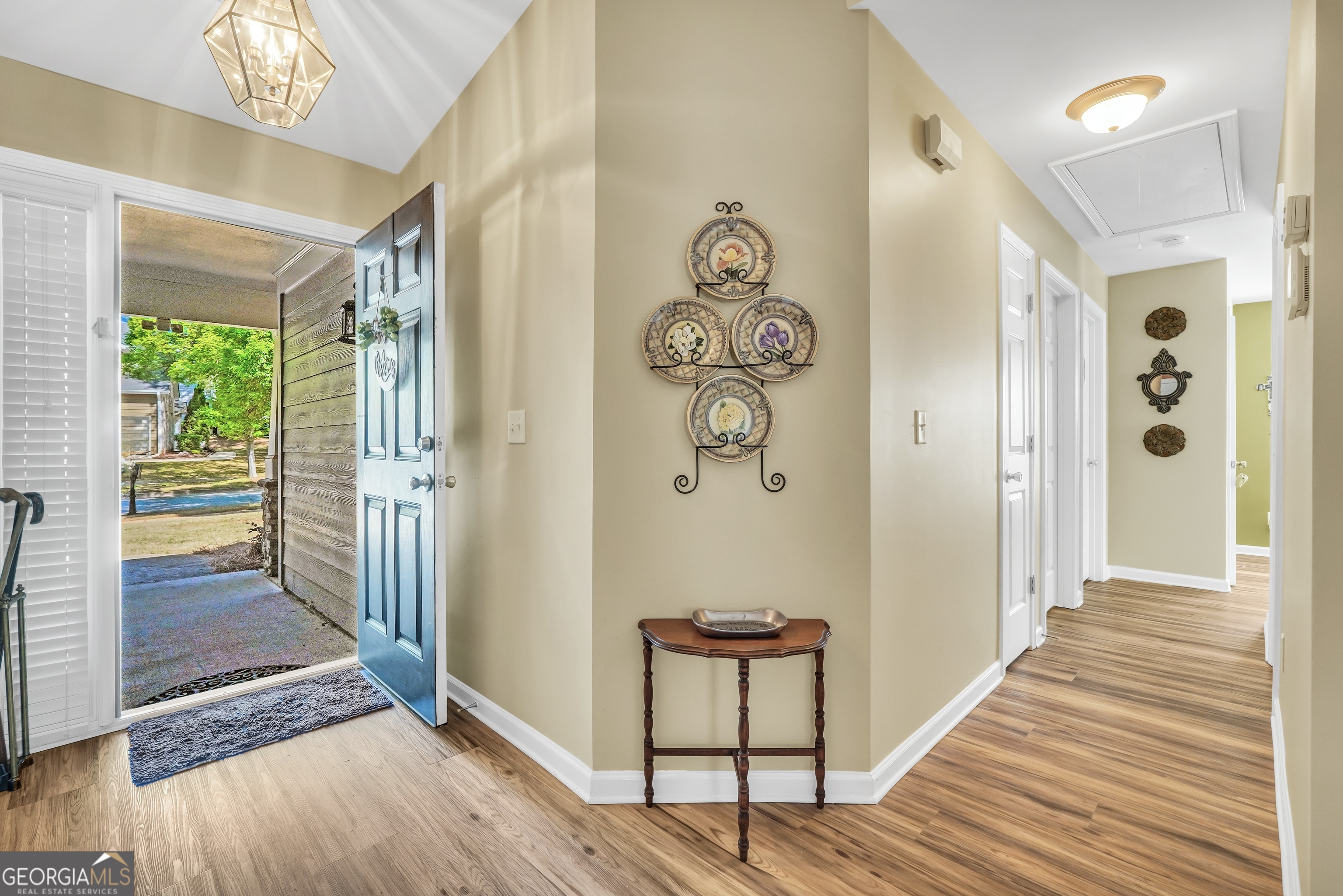 164 Lantana Drive Locust Grove, GA 30248 - Photo 5 of 34 a view of a hallway with wooden floor and staircase