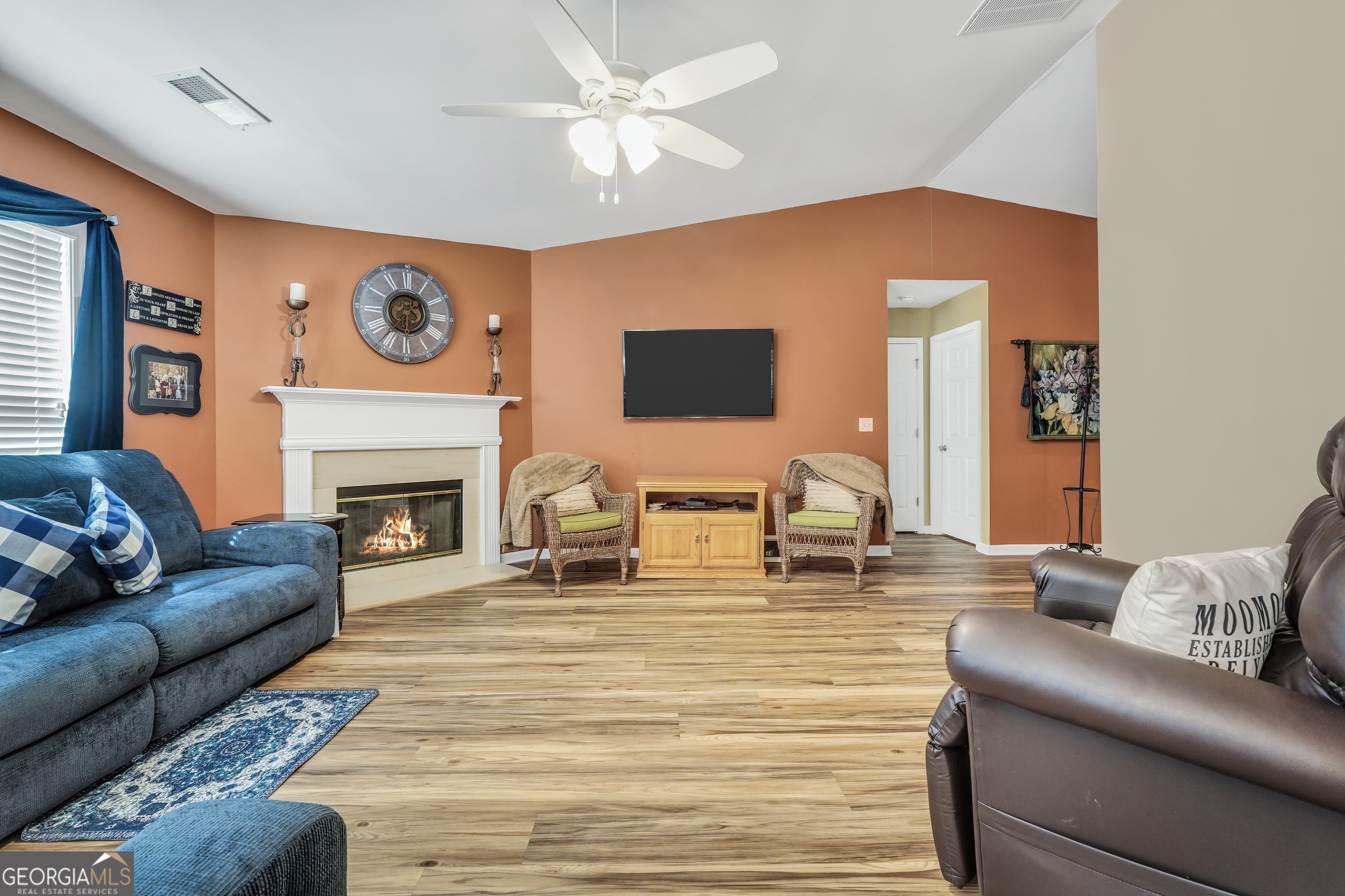 164 Lantana Drive Locust Grove, GA 30248 - Photo 7 of 34 a living room with furniture a fireplace and a flat screen tv