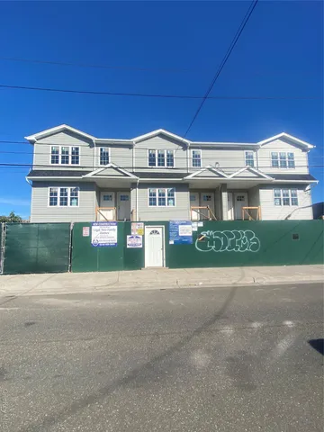 a view of a building with many windows and a road