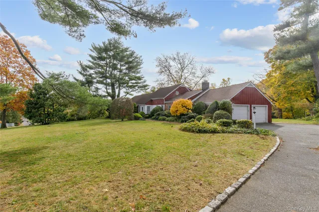 a view of a house with a yard and garage