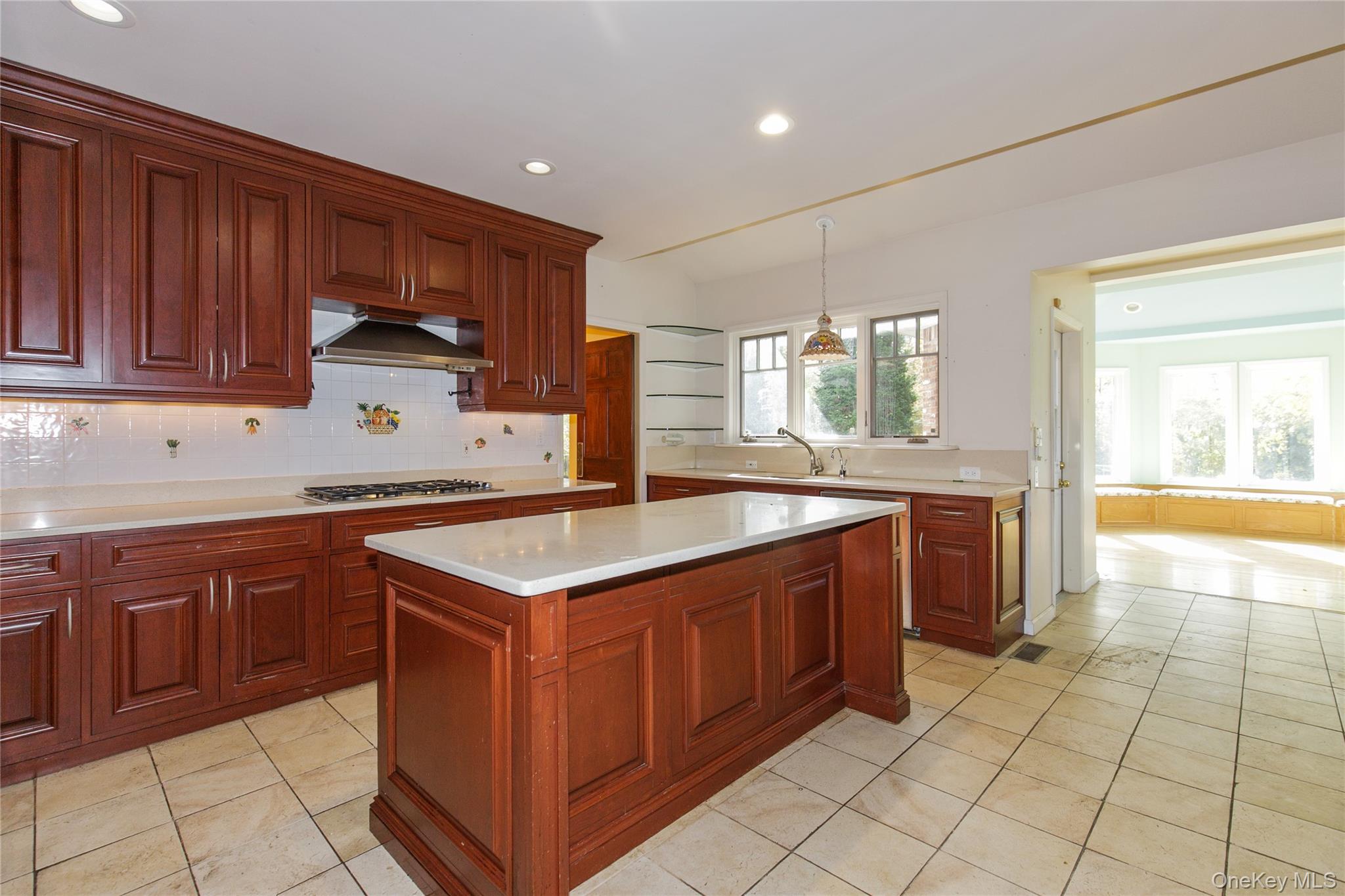 18 Lighthouse Road Kings Point, NY 11024 - Photo 11 of 36 a kitchen with stainless steel appliances granite countertop a sink counter space cabinets and a large window