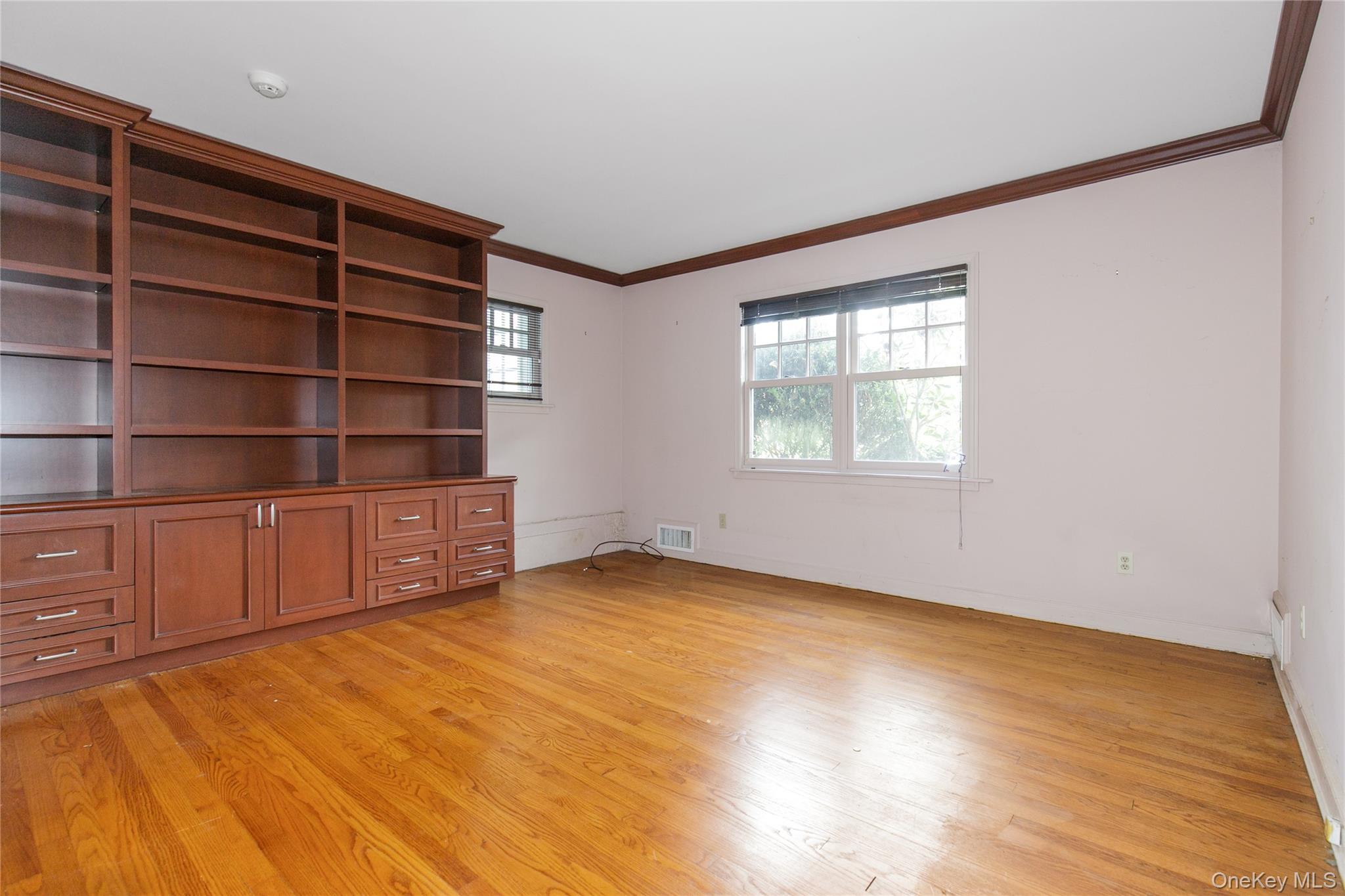 18 Lighthouse Road Kings Point, NY 11024 - Photo 15 of 36 a view of an empty room with a window and wooden floor