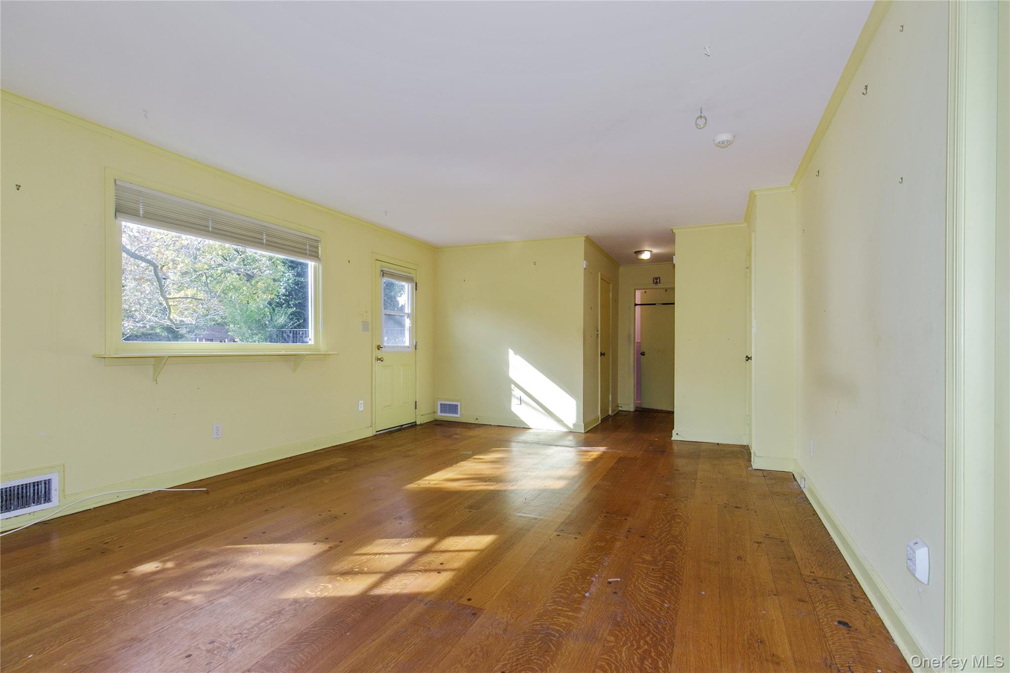 18 Lighthouse Road Kings Point, NY 11024 - Photo 18 of 36 a view of a big room with wooden floor and windows
