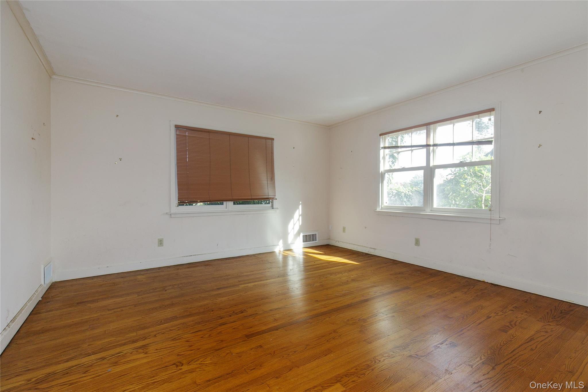 18 Lighthouse Road Kings Point, NY 11024 - Photo 21 of 36 a view of an empty room with wooden floor and a window
