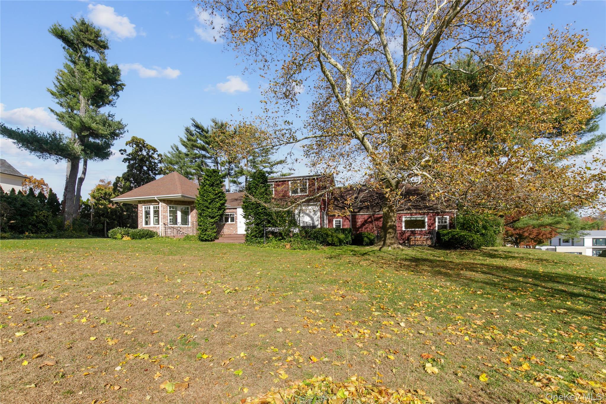 18 Lighthouse Road Kings Point, NY 11024 - Photo 30 of 36 a front view of a house with a yard and trees
