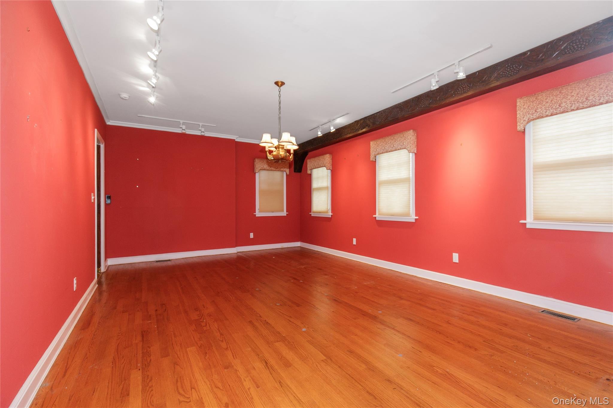 18 Lighthouse Road Kings Point, NY 11024 - Photo 6 of 36 a view of an empty room with window and wooden floor