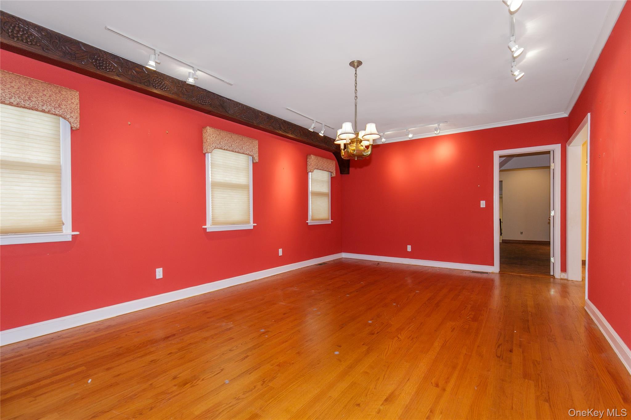 18 Lighthouse Road Kings Point, NY 11024 - Photo 7 of 36 a view of an empty room with window and wooden floor