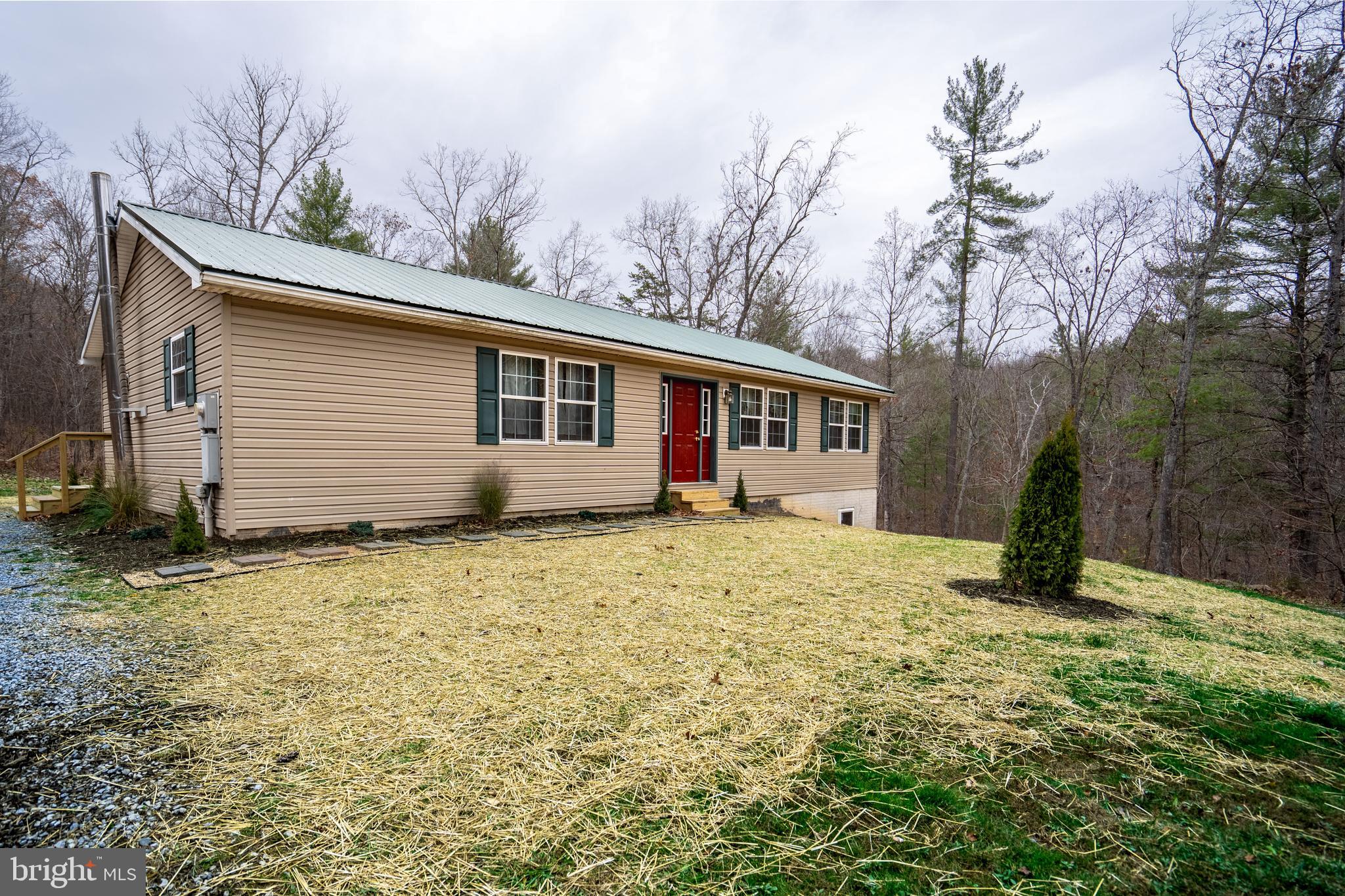 1950 Mesner Road Berkeley Springs, WV 25411 - Photo 1 of 34 a house with trees in the background