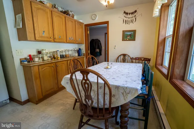 a view of a dining room with furniture and a chandelier