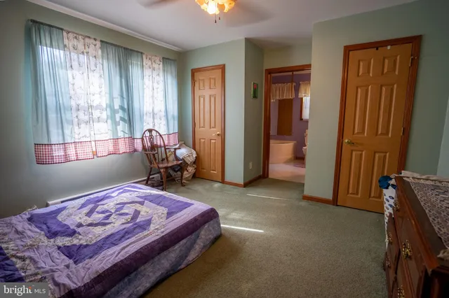 a bed sitting in a room next to a window