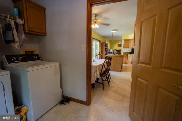 a view of a dining room with furniture and a fan