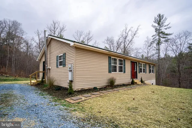 a view of a house with a yard covered in snow