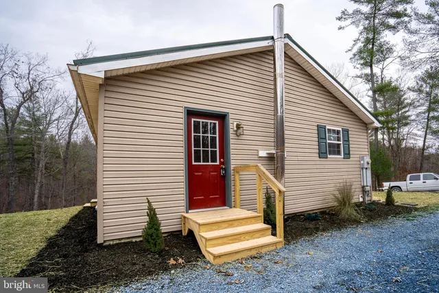 a view of a house with a yard and stairs