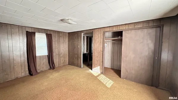 a spacious bedroom with a bed and a window