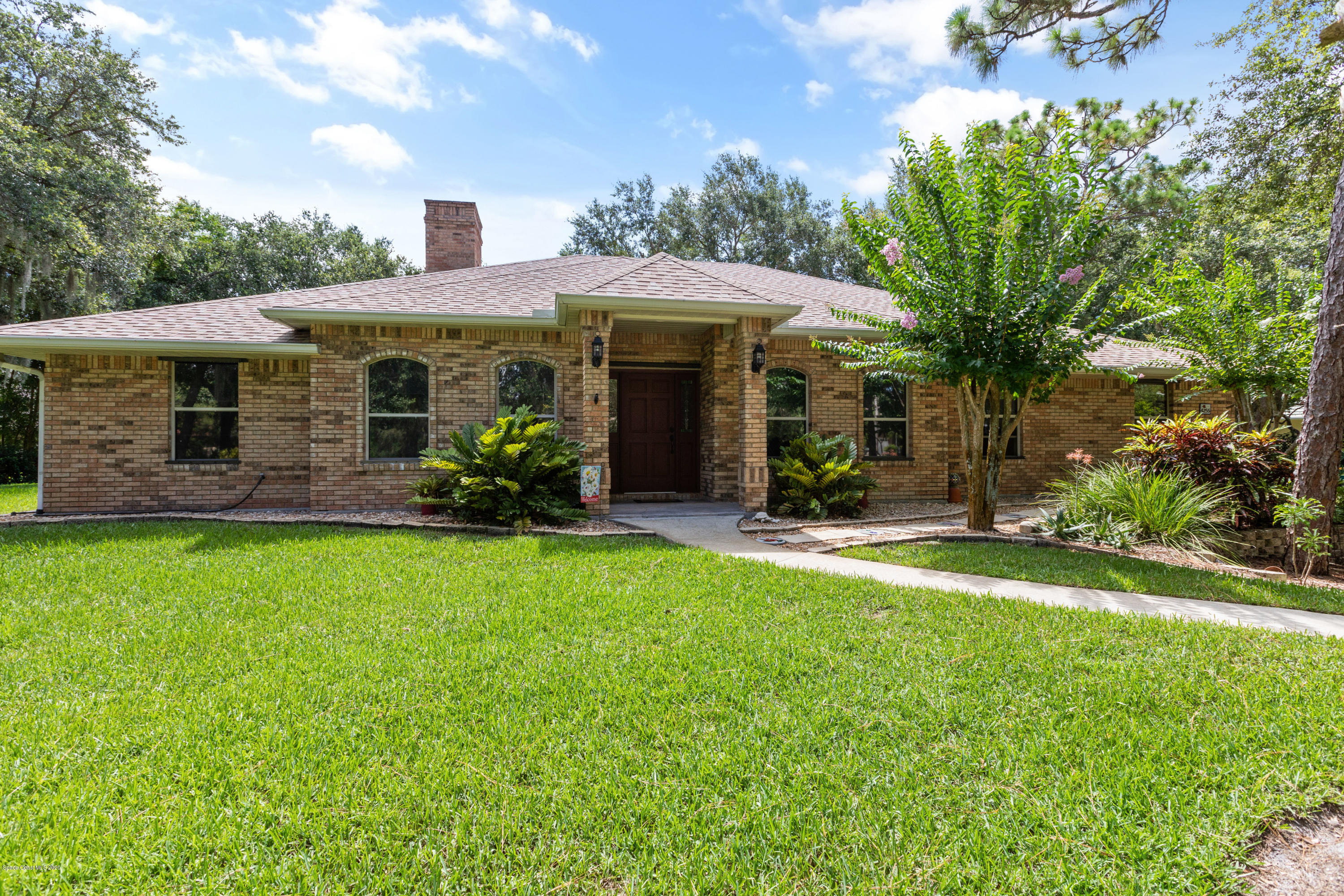 4255 Turtle Mound Road Melbourne, FL 32934 - Photo 1 of 46 a front view of a house with garden