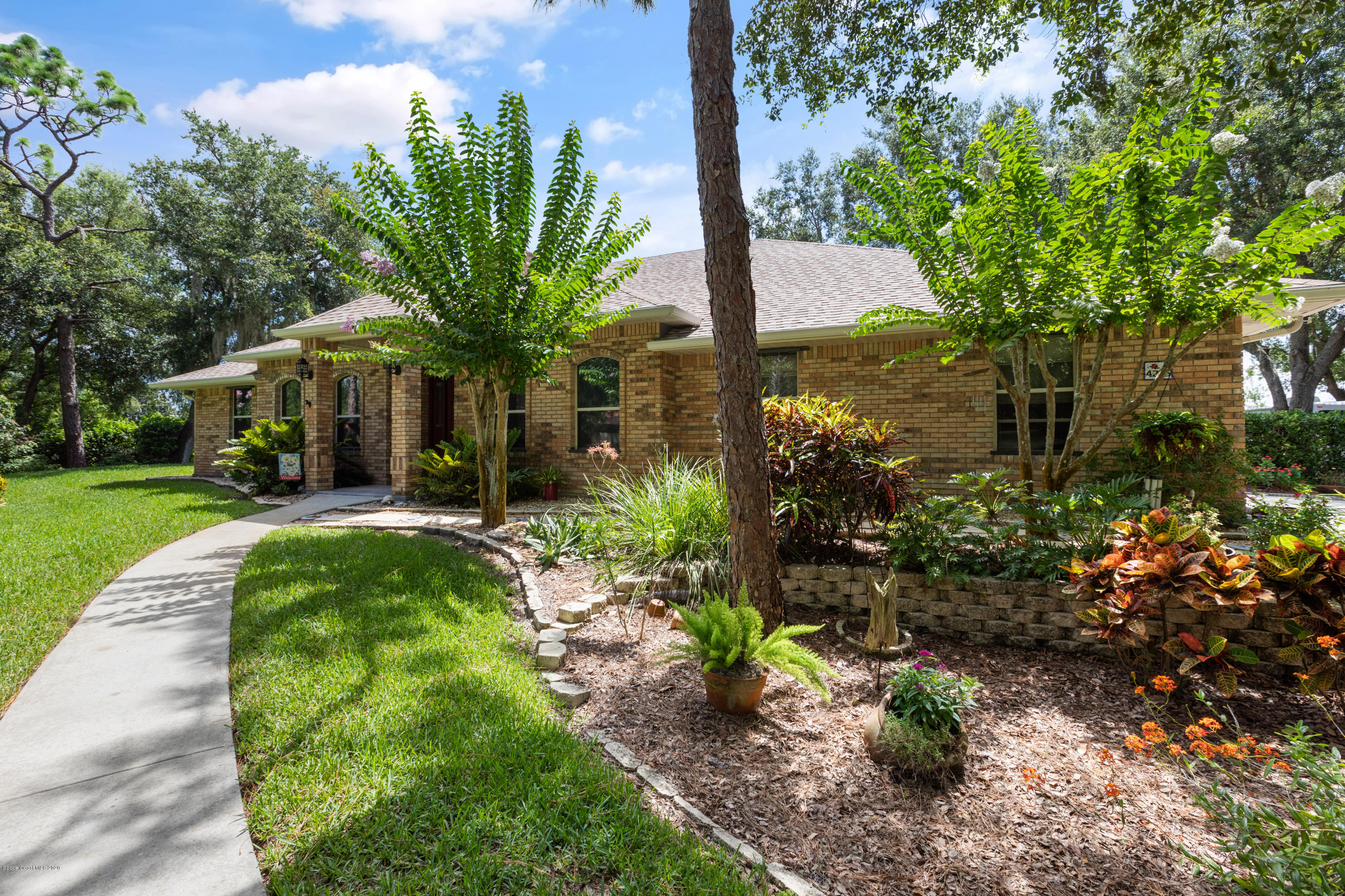 4255 Turtle Mound Road Melbourne, FL 32934 - Photo 2 of 46 a view of a house with a garden