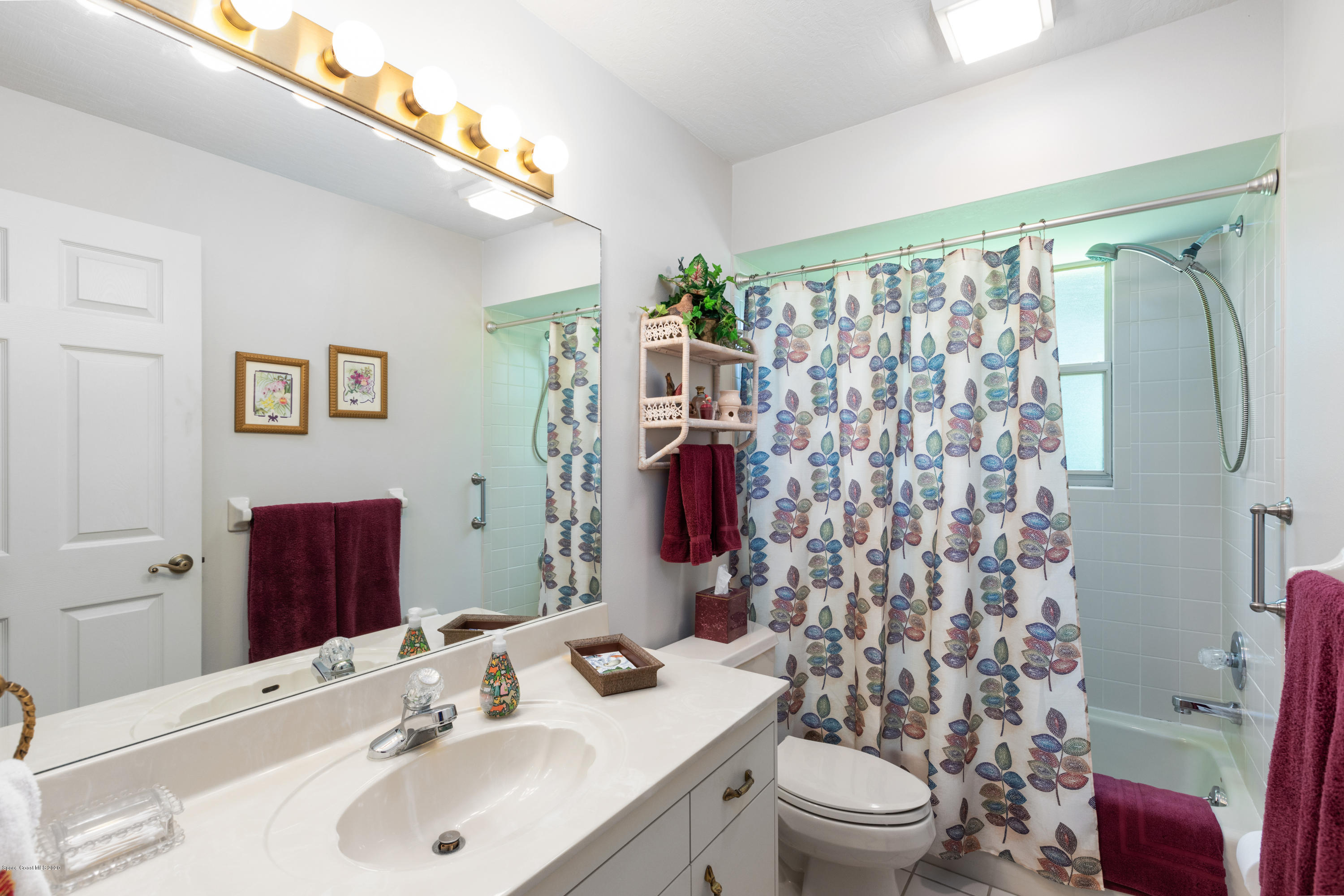 4255 Turtle Mound Road Melbourne, FL 32934 - Photo 14 of 46 a bathroom with a sink toilet and shower