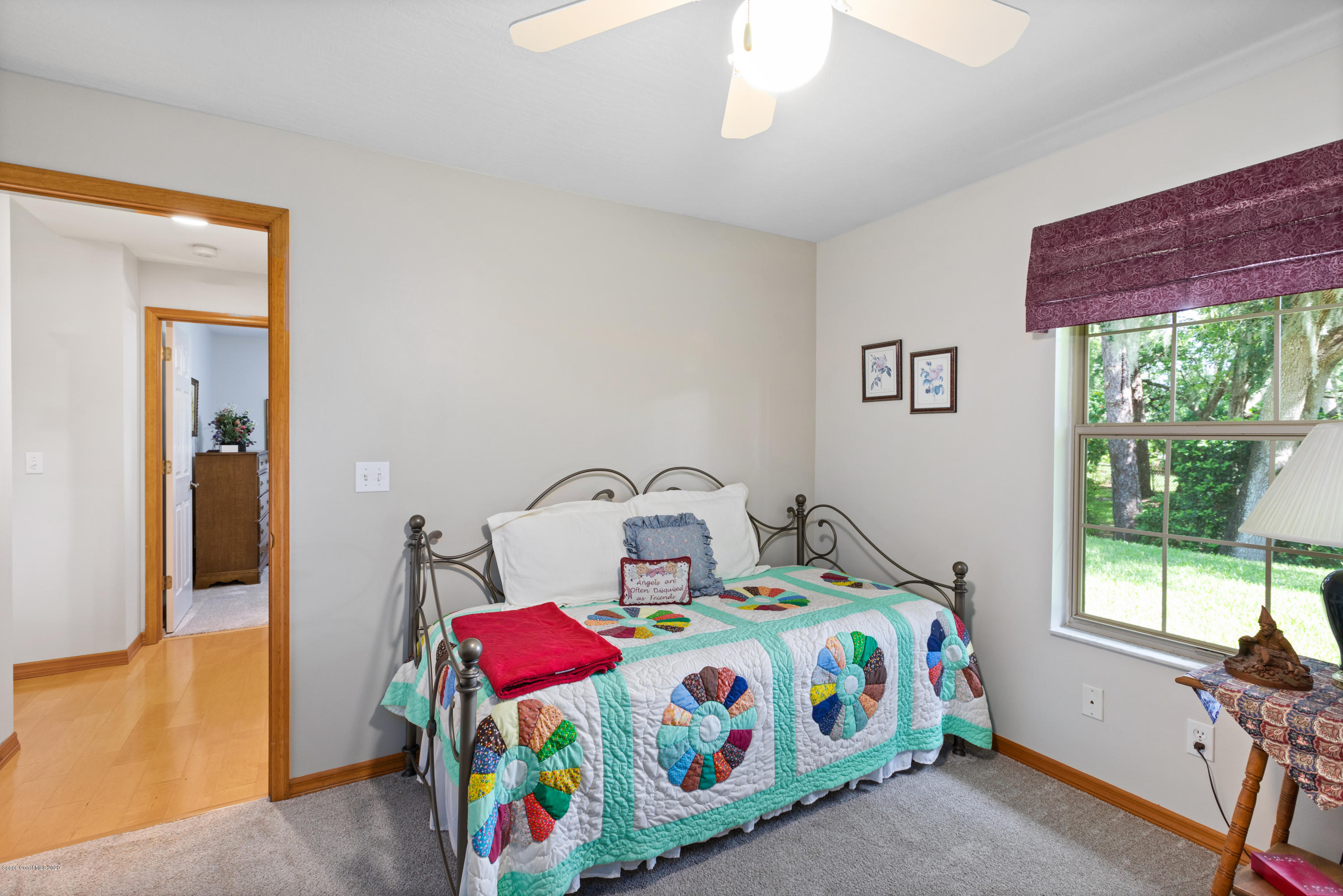 4255 Turtle Mound Road Melbourne, FL 32934 - Photo 16 of 46 a bedroom with a bed table and a window