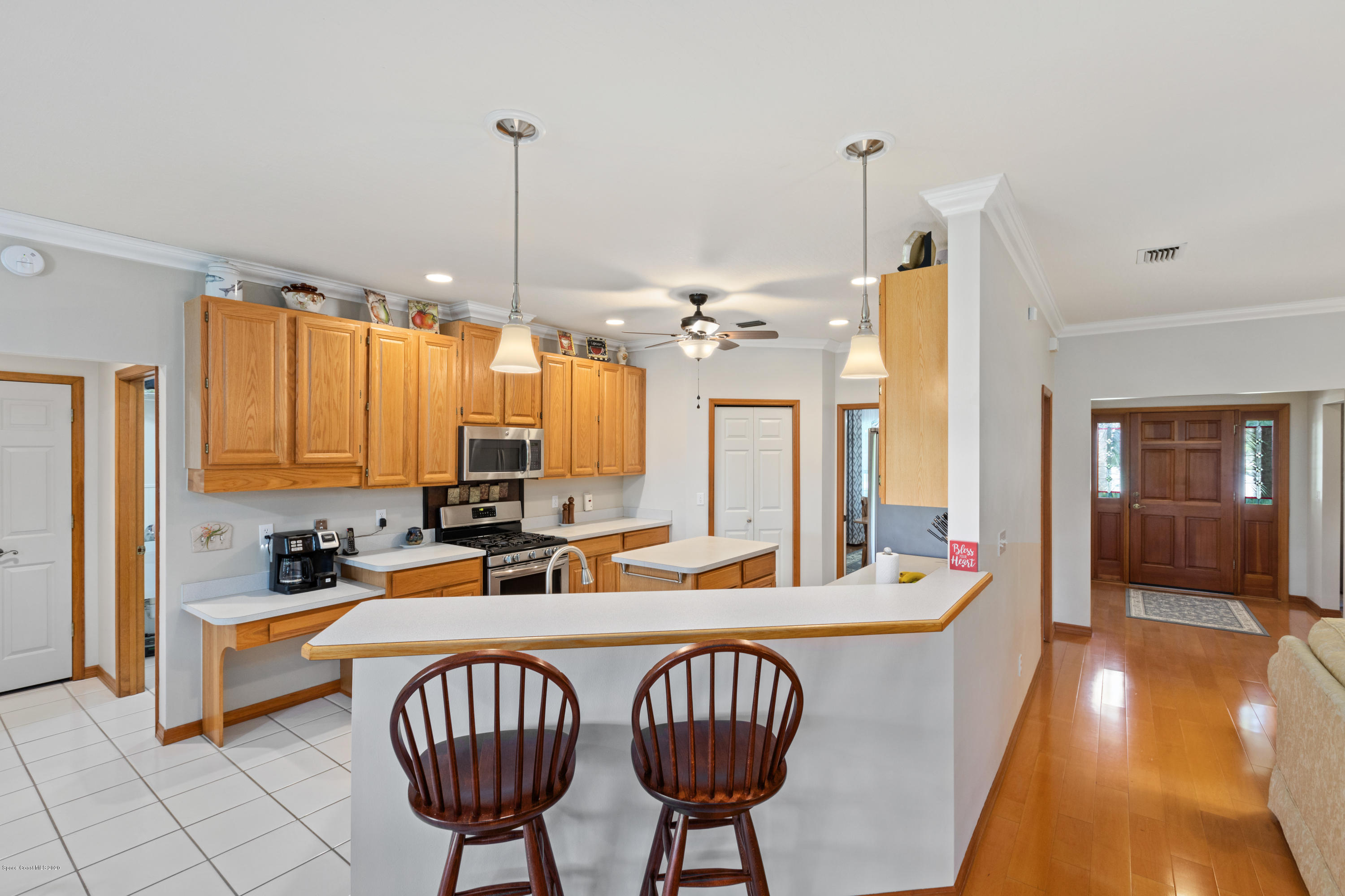 4255 Turtle Mound Road Melbourne, FL 32934 - Photo 20 of 46 a kitchen with stainless steel appliances a sink and a large window