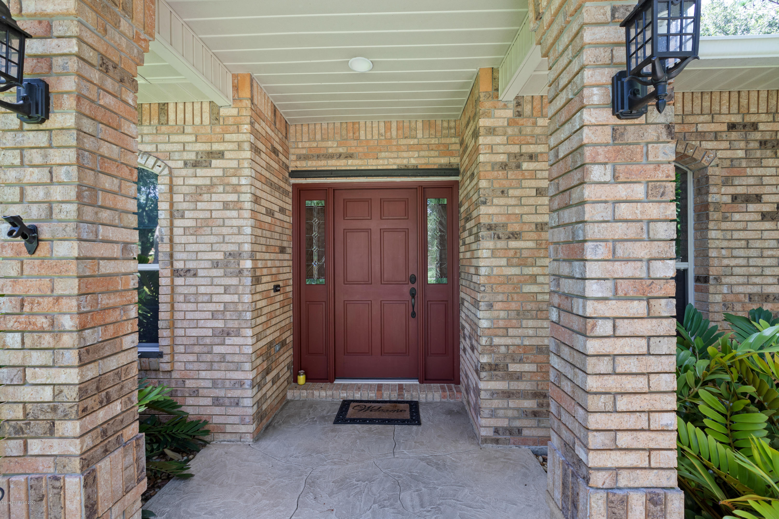 4255 Turtle Mound Road Melbourne, FL 32934 - Photo 3 of 46 a brick building with a door