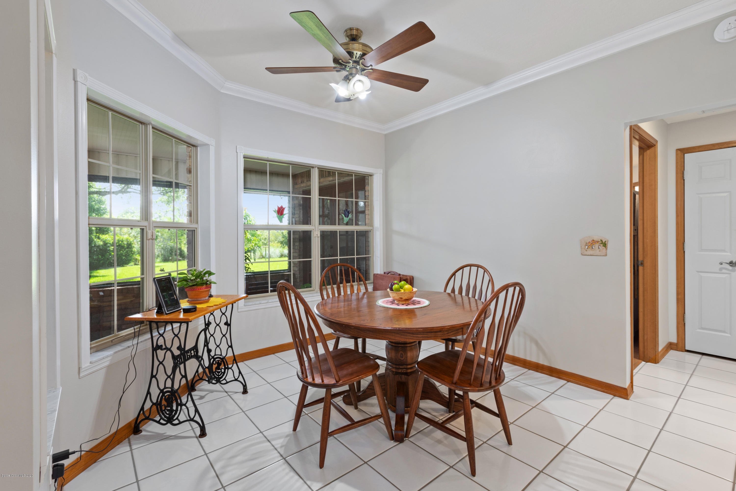 4255 Turtle Mound Road Melbourne, FL 32934 - Photo 21 of 46 a view of a dining room with furniture and a potted plant
