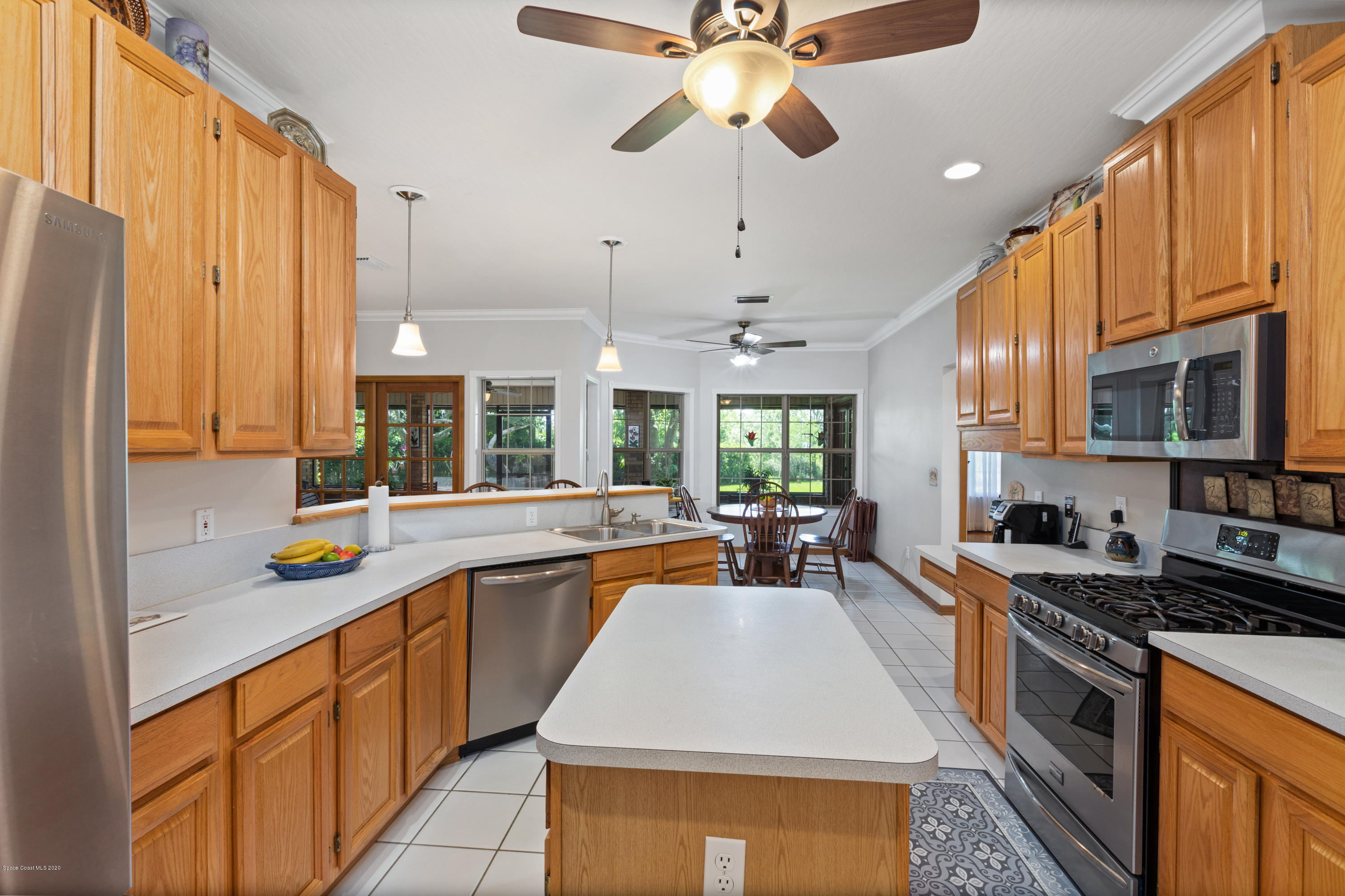 4255 Turtle Mound Road Melbourne, FL 32934 - Photo 23 of 46 a kitchen with stainless steel appliances a stove a sink and cabinets