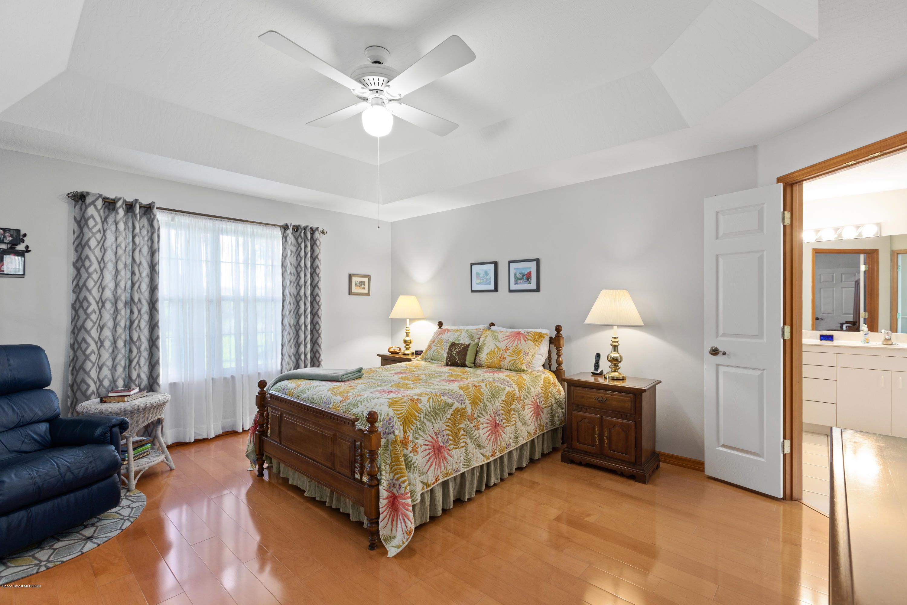 4255 Turtle Mound Road Melbourne, FL 32934 - Photo 24 of 46 a spacious bedroom with a bed a couch and dresser