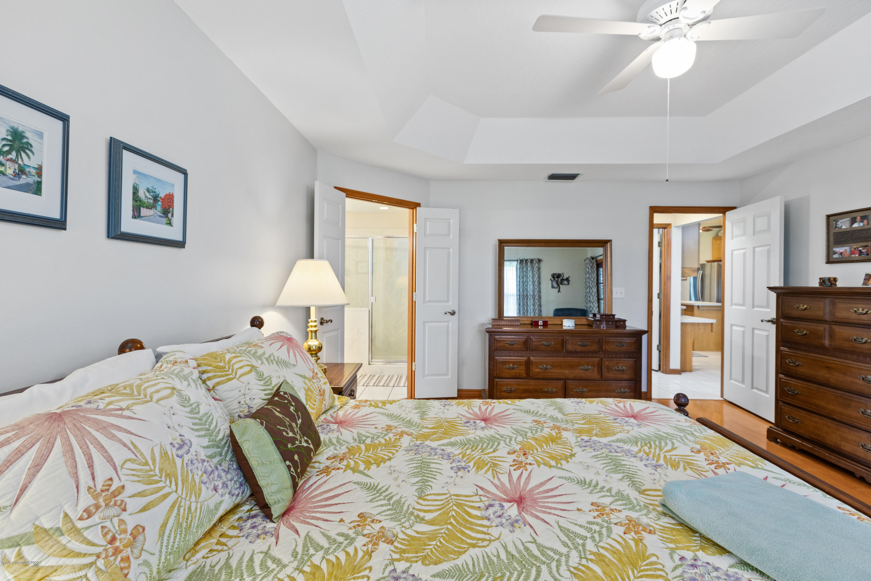 4255 Turtle Mound Road Melbourne, FL 32934 - Photo 25 of 46 a bedroom with a bed and a chandelier