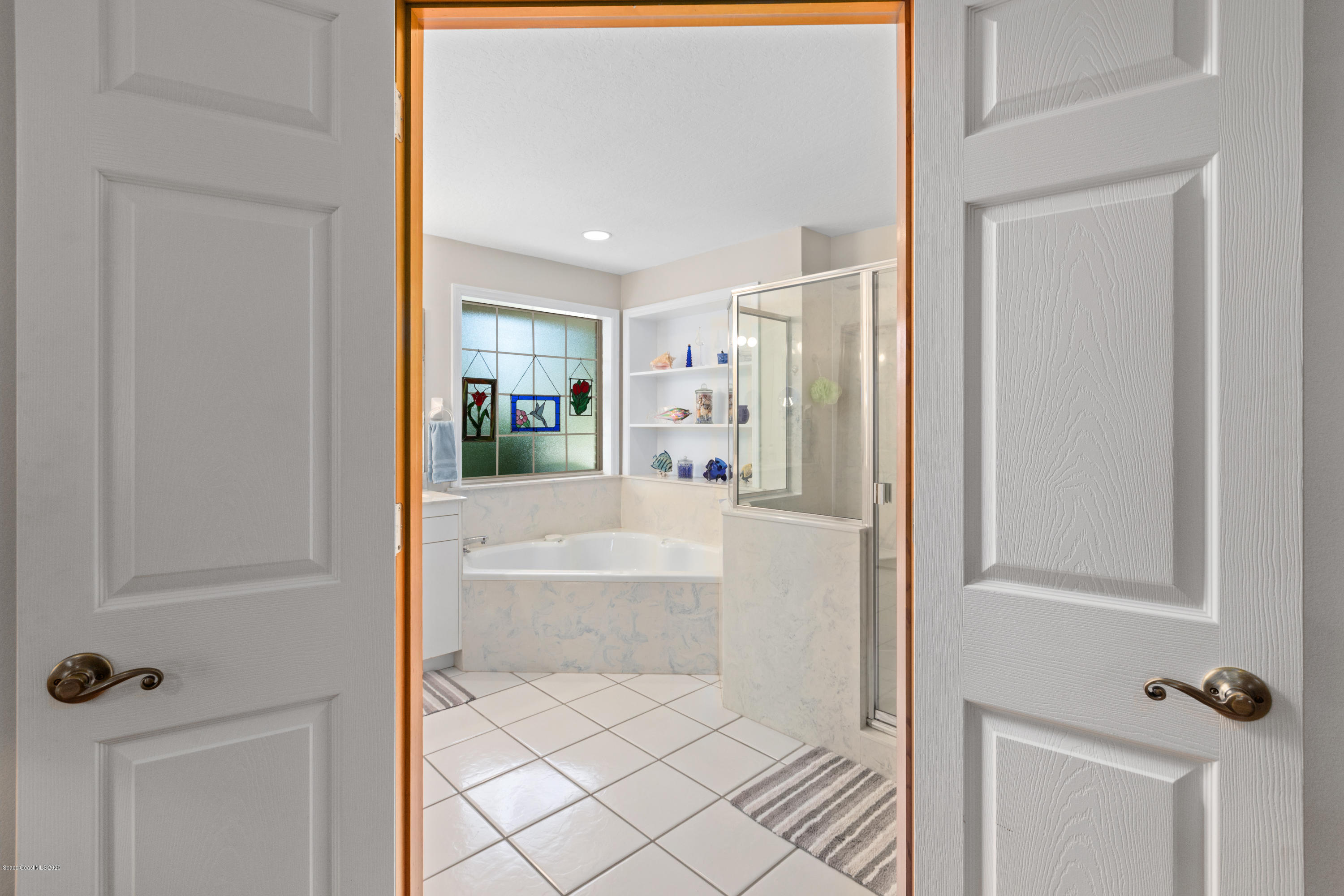 4255 Turtle Mound Road Melbourne, FL 32934 - Photo 26 of 46 a bathroom with a bathtub and shower