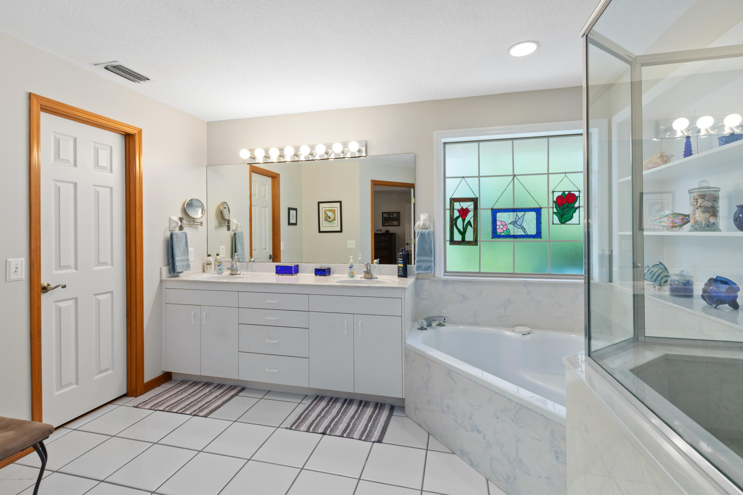 4255 Turtle Mound Road Melbourne, FL 32934 - Photo 27 of 46 a bathroom with a tub sink and mirror