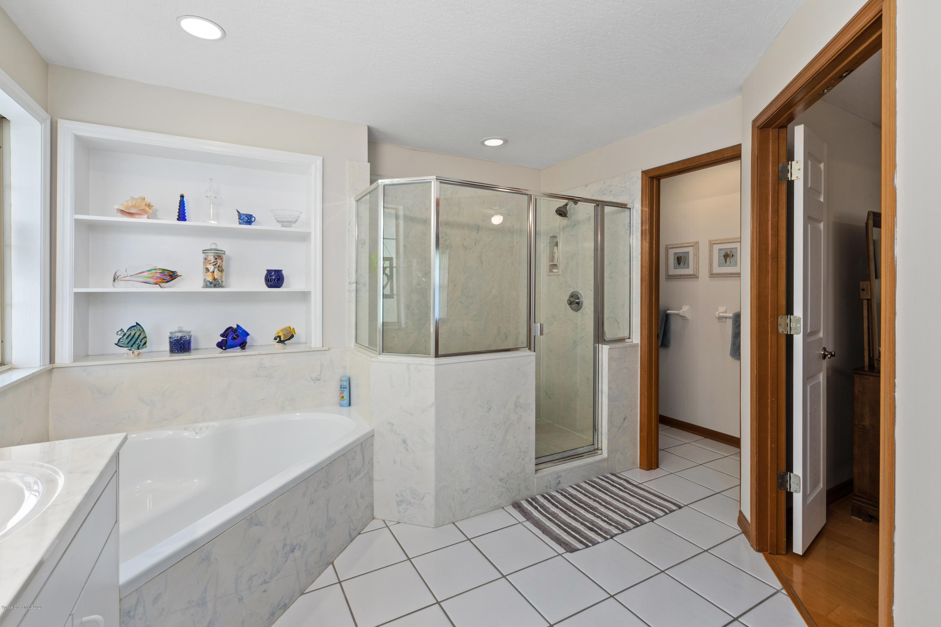 4255 Turtle Mound Road Melbourne, FL 32934 - Photo 28 of 46 a bathroom with a bathtub and a shower