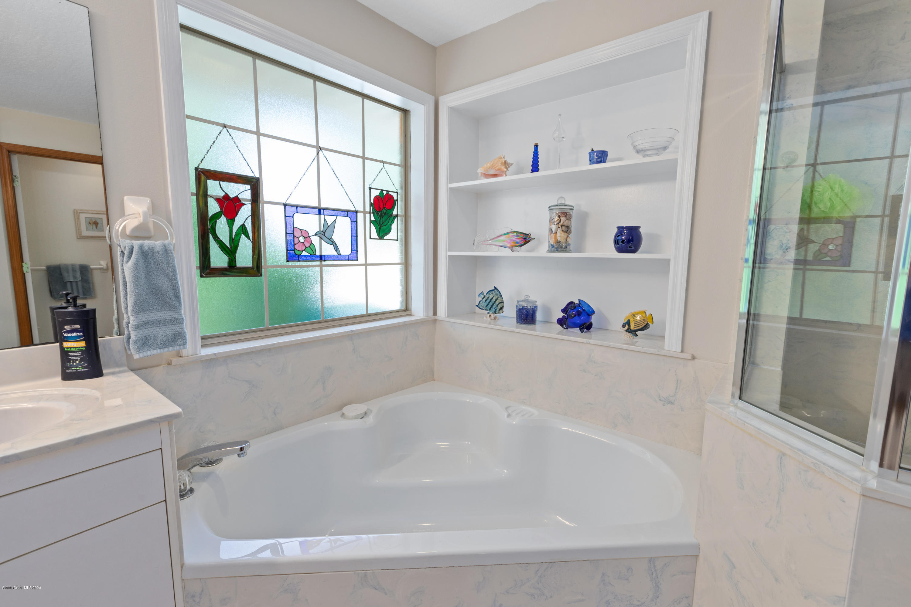 4255 Turtle Mound Road Melbourne, FL 32934 - Photo 29 of 46 a white bath tub sitting next to a bathroom