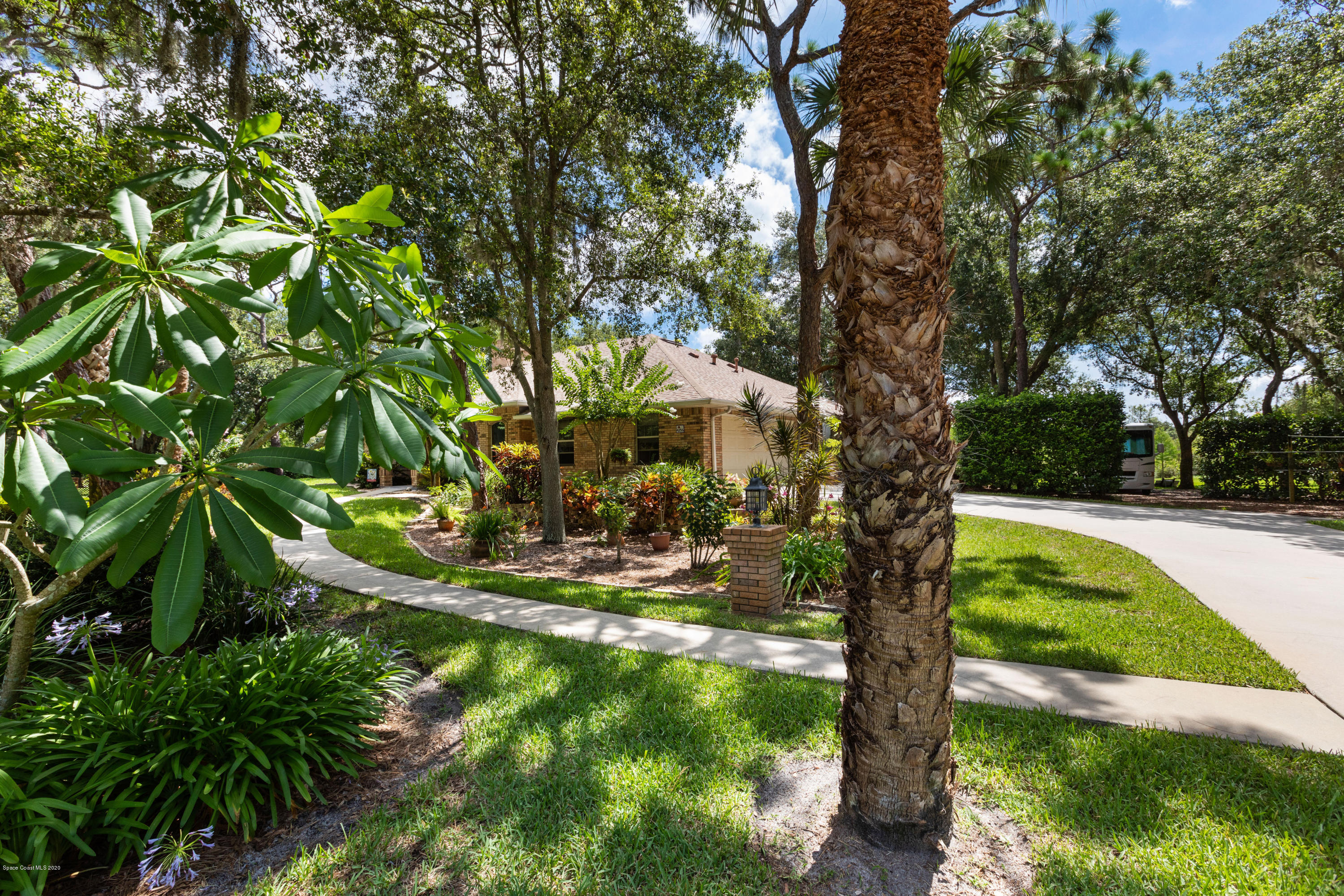 4255 Turtle Mound Road Melbourne, FL 32934 - Photo 4 of 46 a view of a garden with a tree