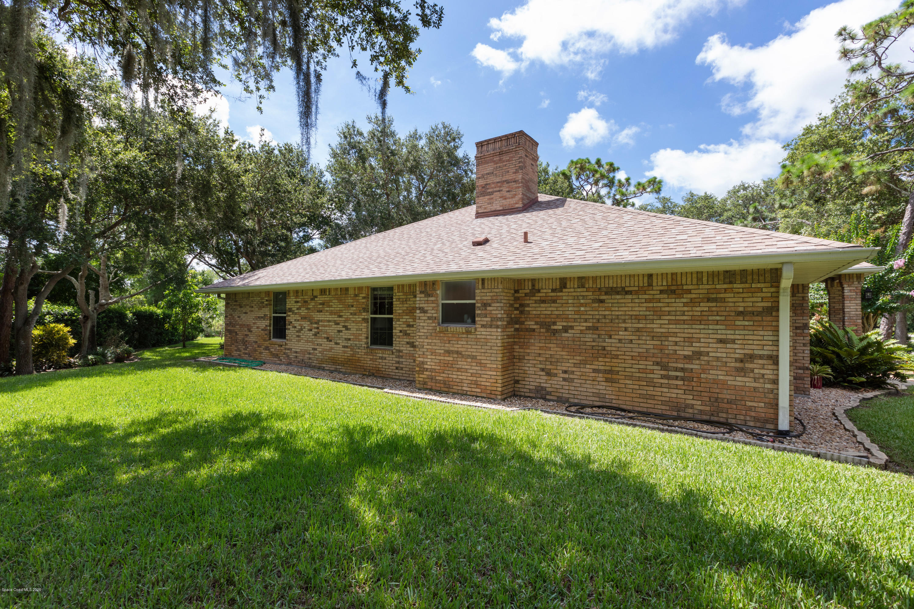 4255 Turtle Mound Road Melbourne, FL 32934 - Photo 35 of 46 a front view of a house with a garden