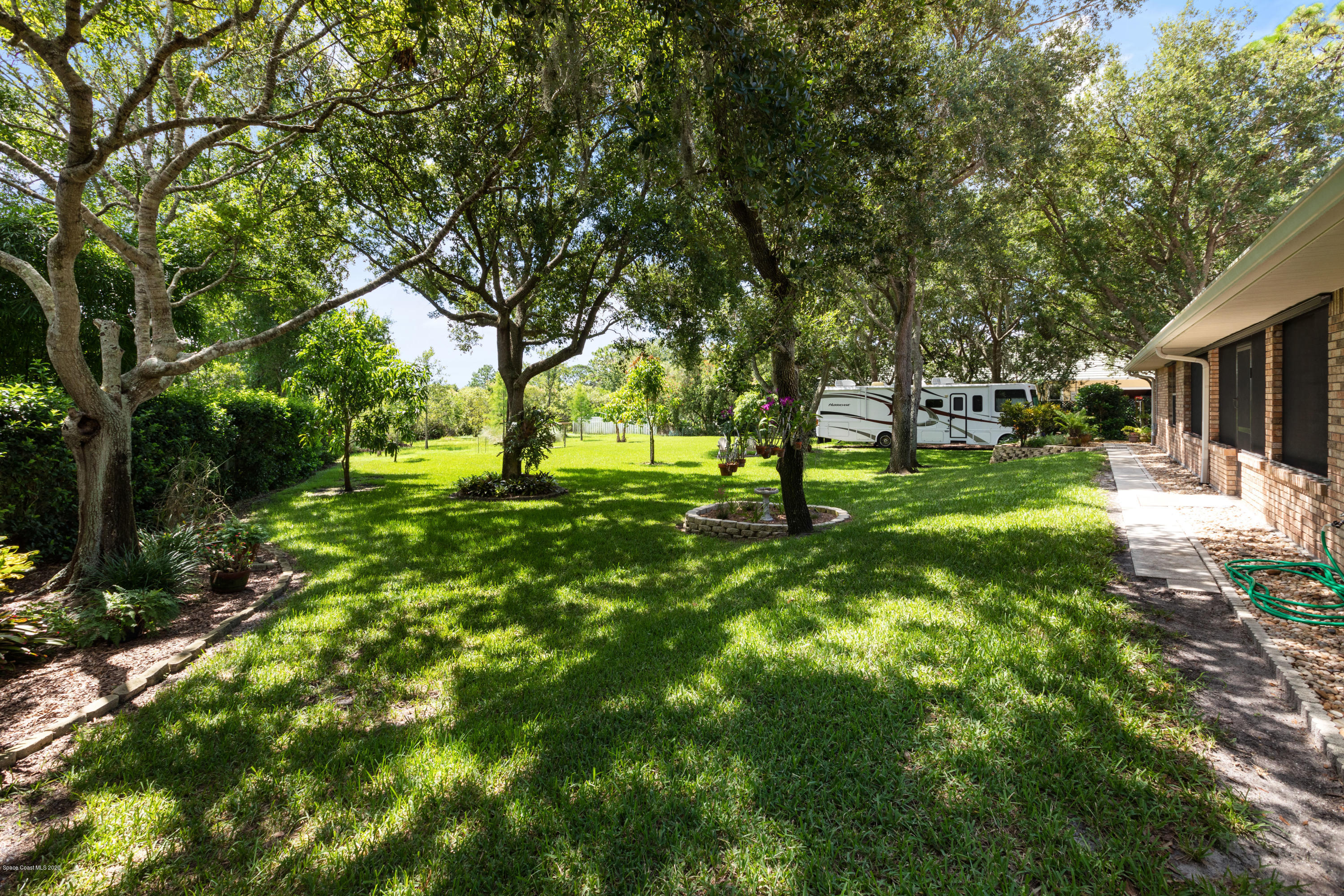 4255 Turtle Mound Road Melbourne, FL 32934 - Photo 36 of 46 a view of yard with green space and trees in the background