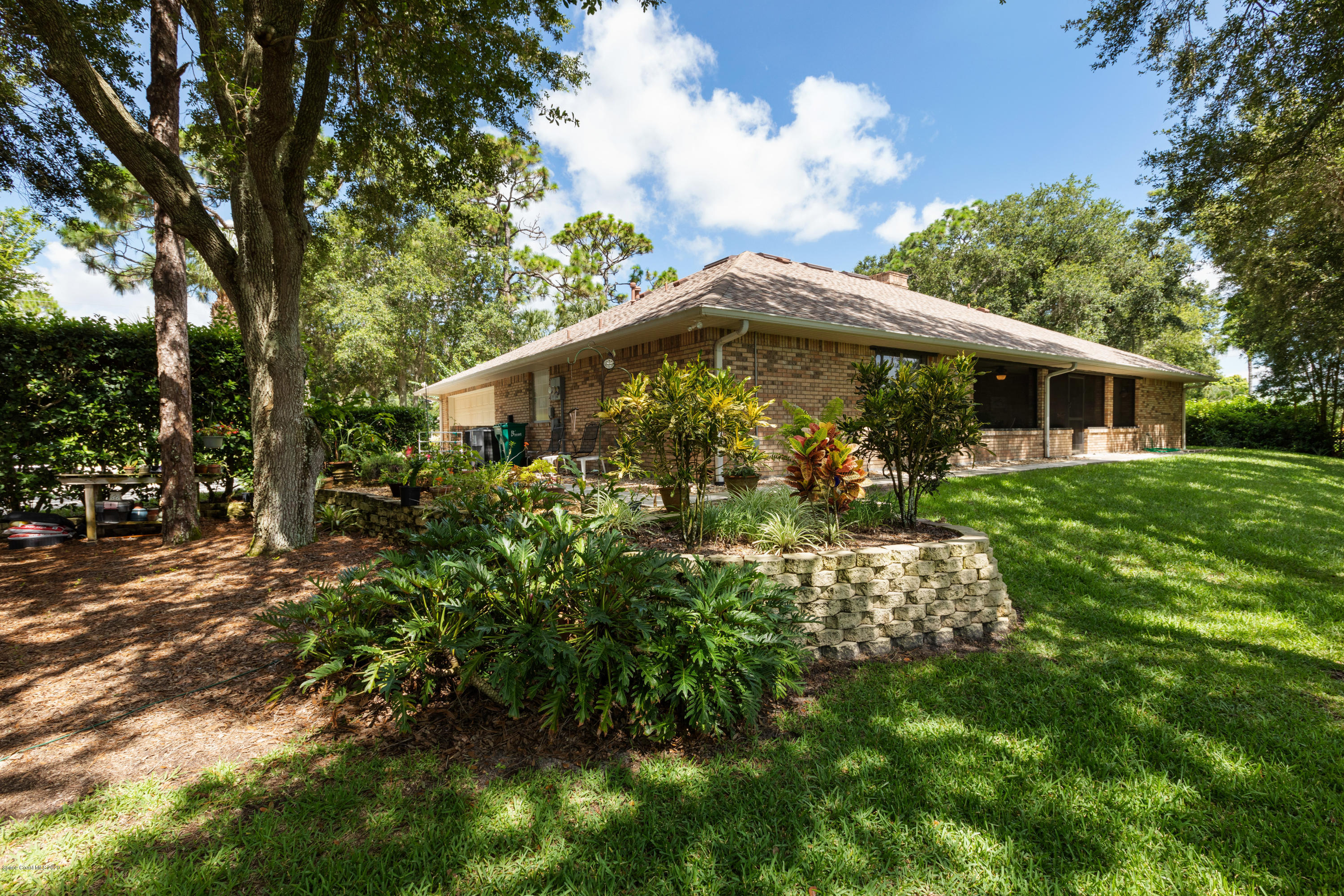 4255 Turtle Mound Road Melbourne, FL 32934 - Photo 40 of 46 a backyard of a house with lots of green space