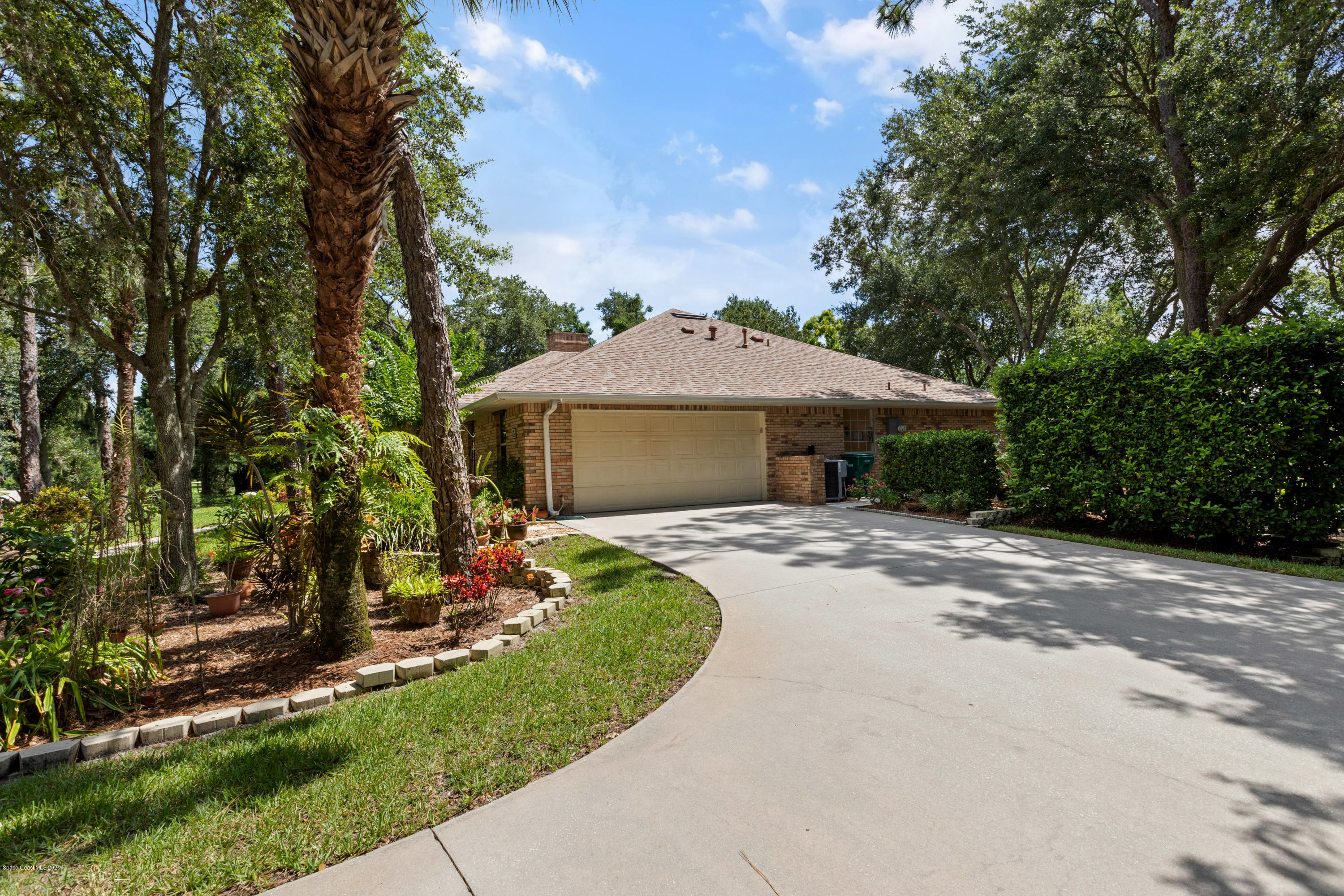 4255 Turtle Mound Road Melbourne, FL 32934 - Photo 42 of 46 a front view of a house with a garden