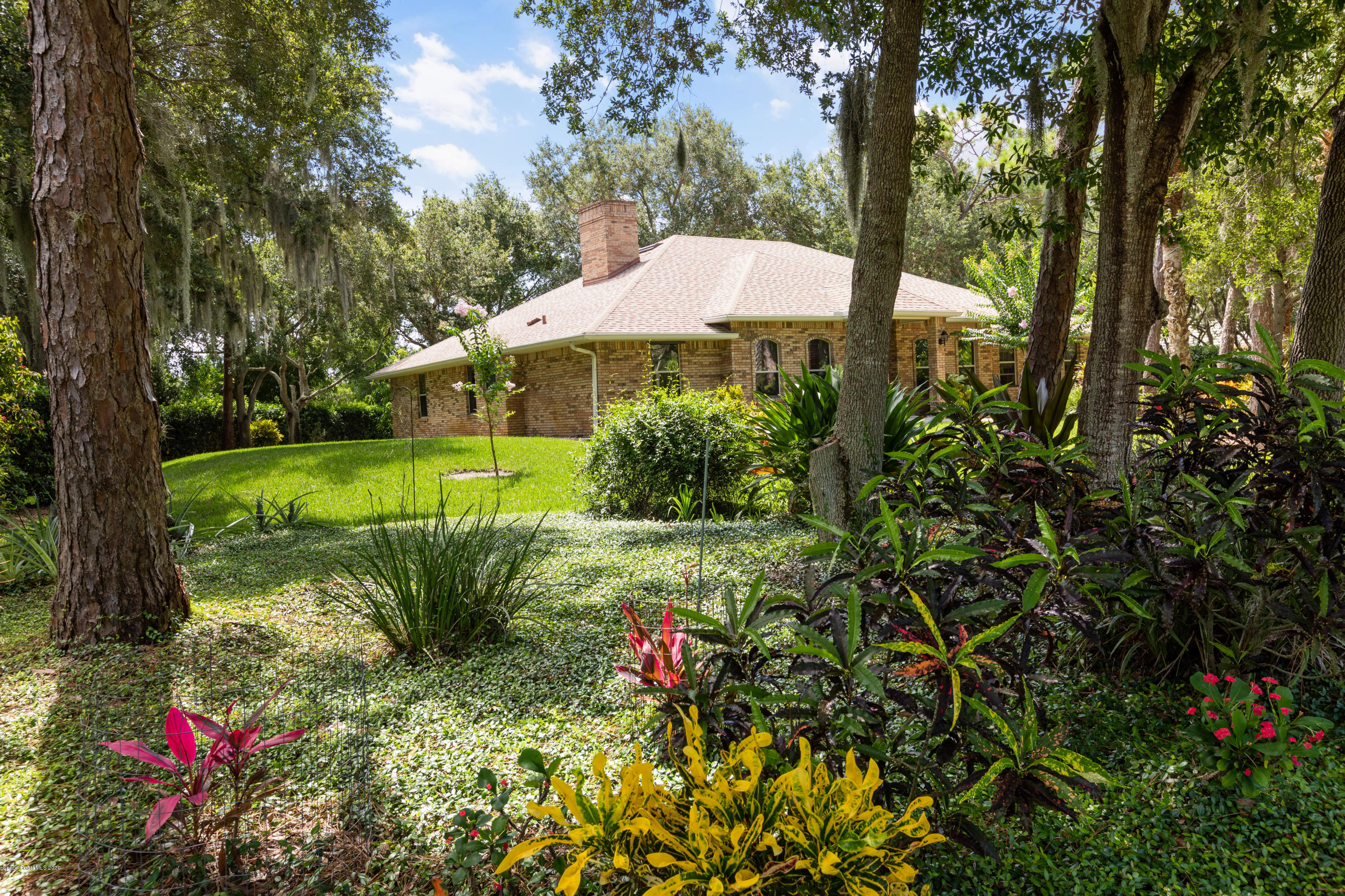 4255 Turtle Mound Road Melbourne, FL 32934 - Photo 46 of 46 a view of a house with a yard and garden