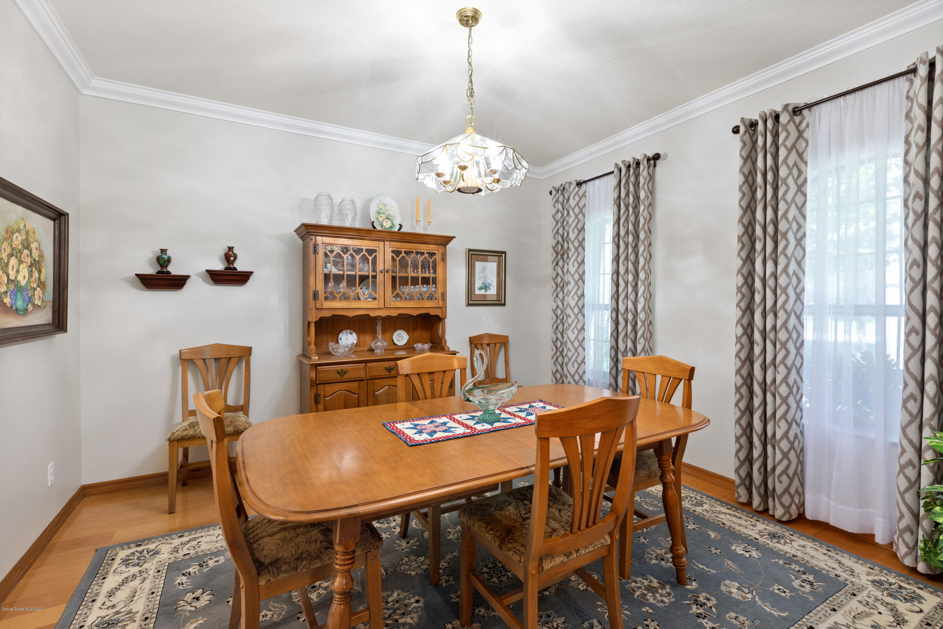 4255 Turtle Mound Road Melbourne, FL 32934 - Photo 8 of 46 a view of a dining room with furniture window and wooden floor