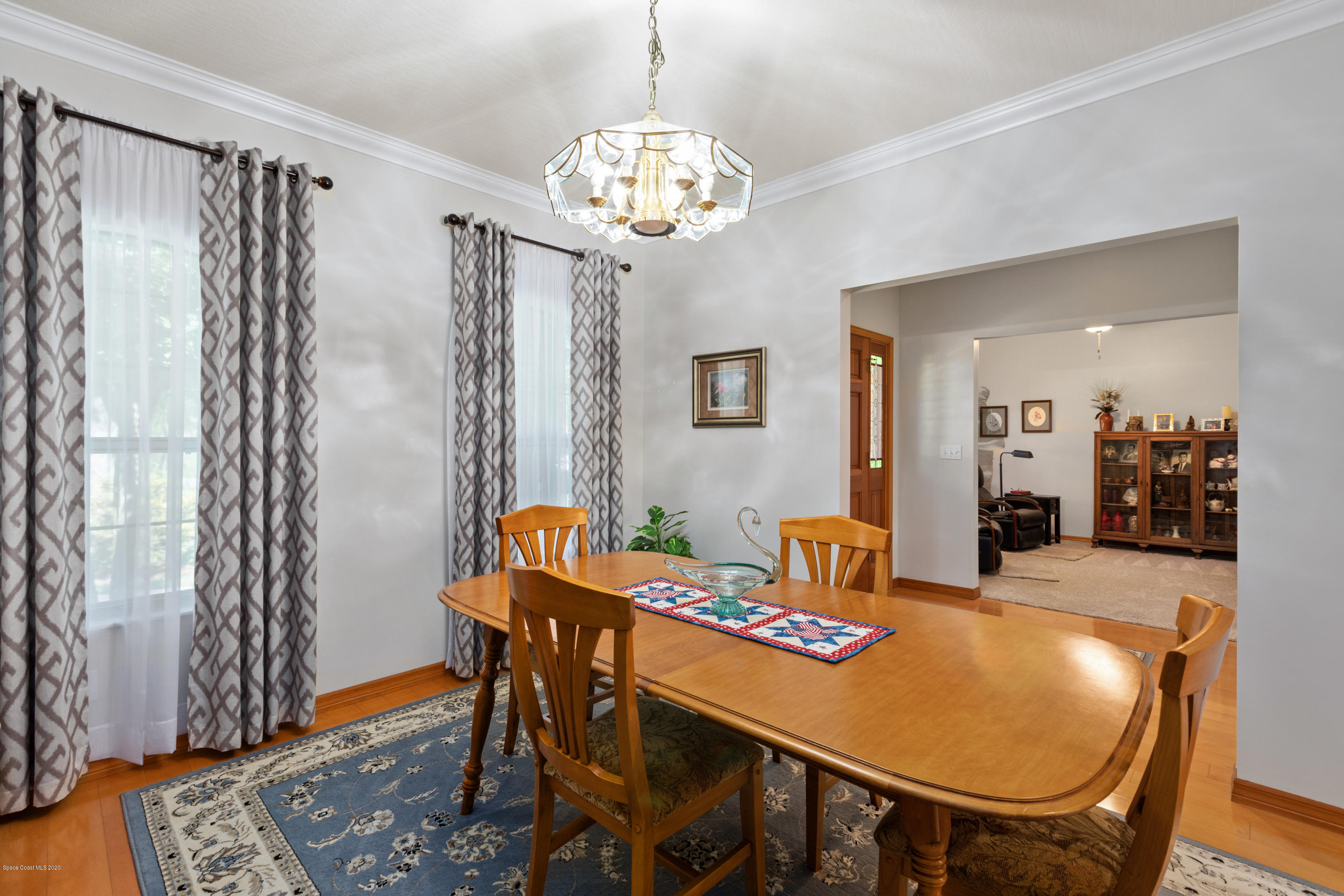 4255 Turtle Mound Road Melbourne, FL 32934 - Photo 9 of 46 a view of a dining room with furniture and chandelier