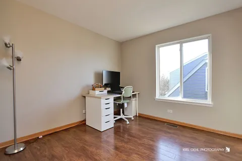 a view of workspace with wooden floor cabinet and windows