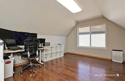 a view of a workspace with furniture and a window