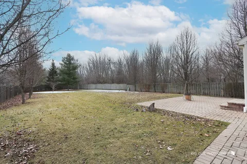 a view of a patio with dining table and chairs with wooden fence